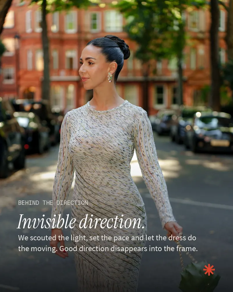 Ellie Evelyn walking past red-brick townhouses in a long patterned dress, with the caption: Invisible direction.